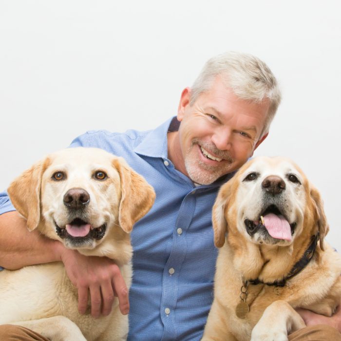 Man with two yellow labs