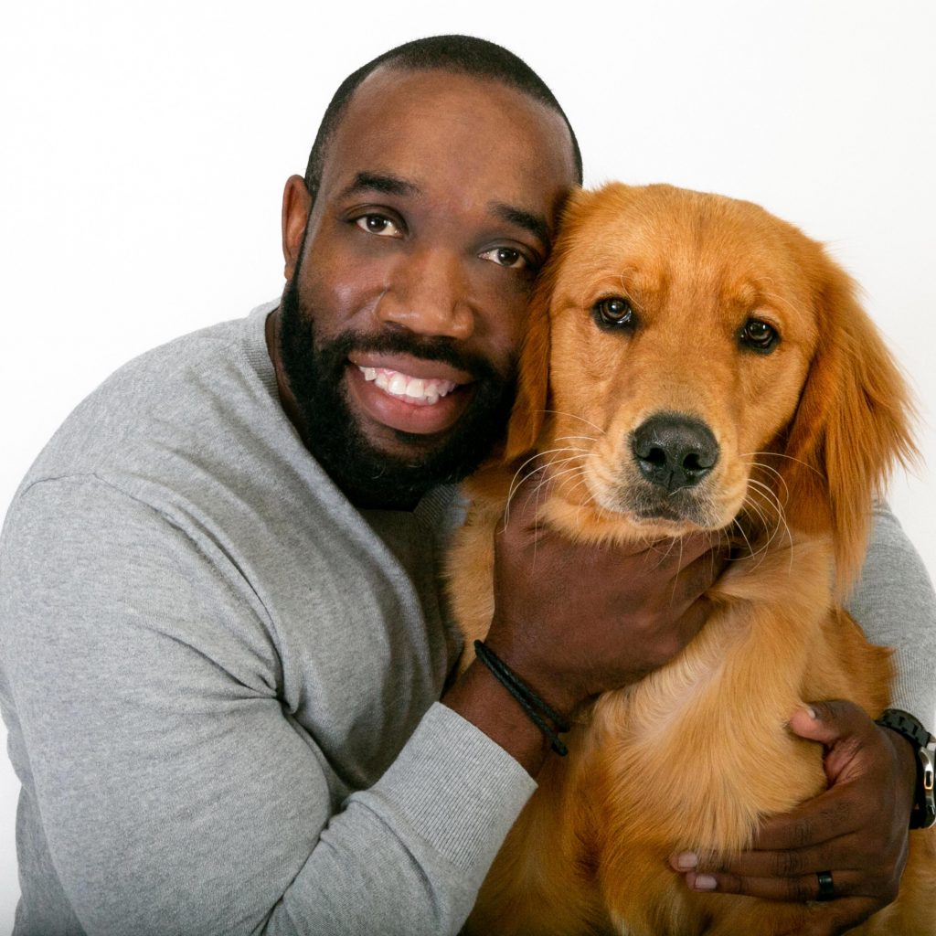 James smiling with a dog