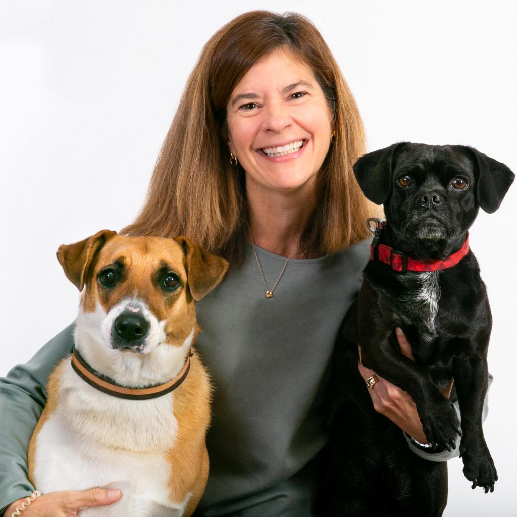 Johanne smiling with two dogs