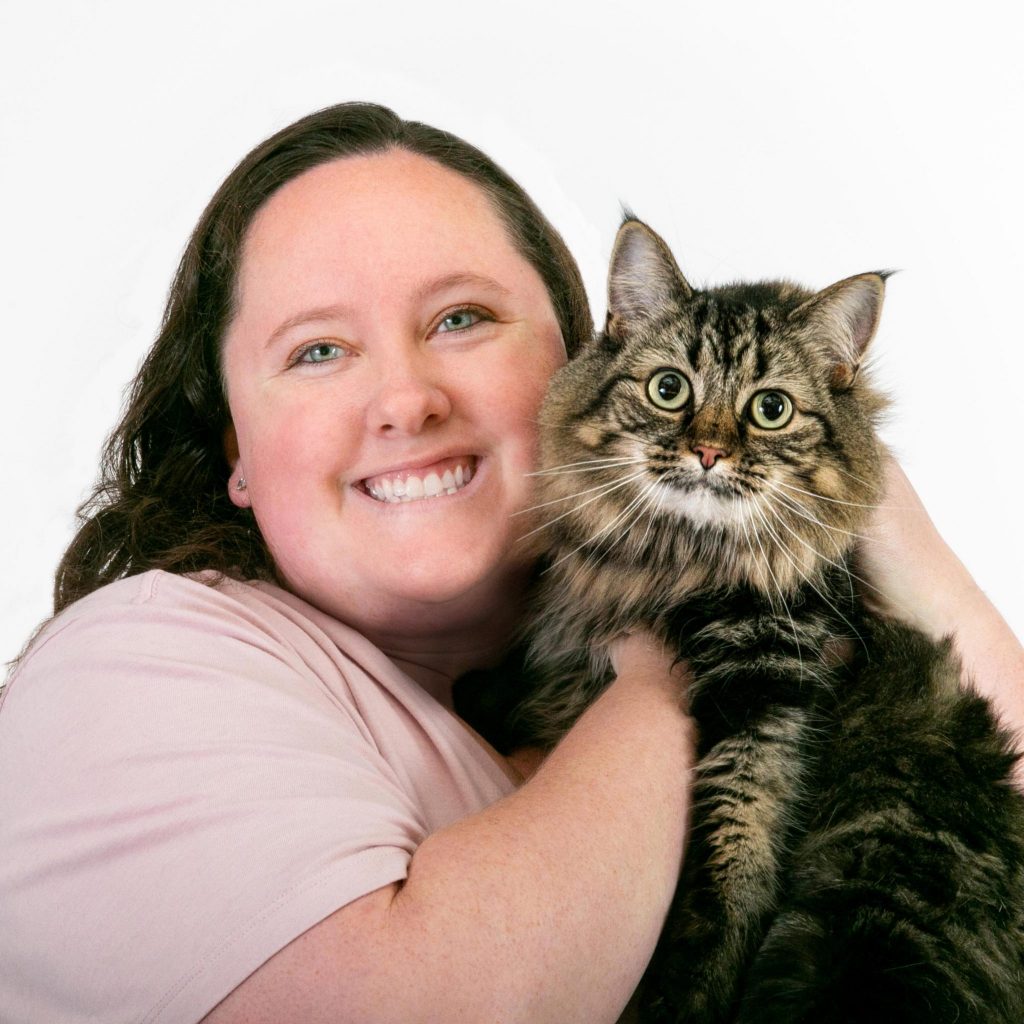 Kelly Slocomb smiling and holding a cat