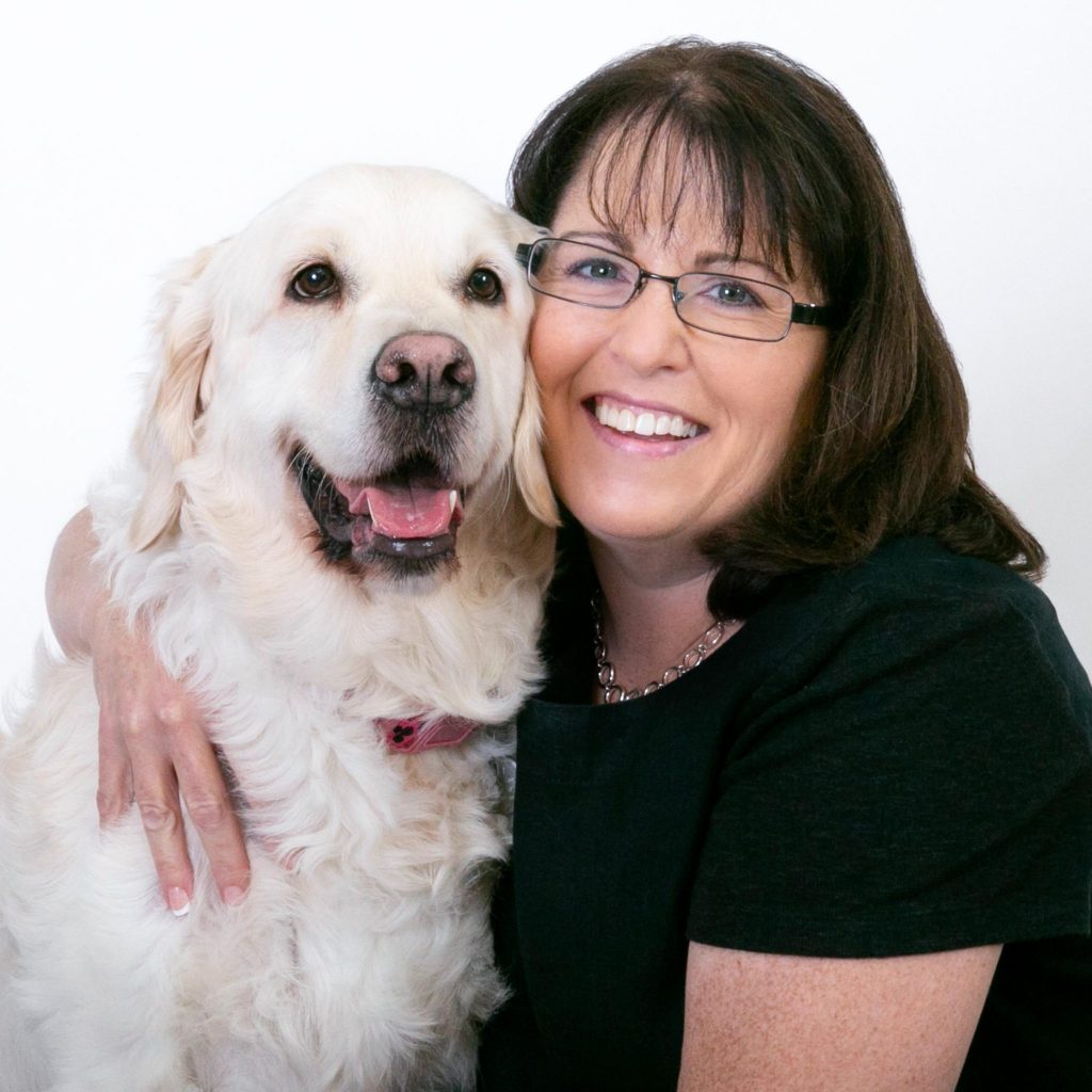 Sherrie Hashey smiling with a dog