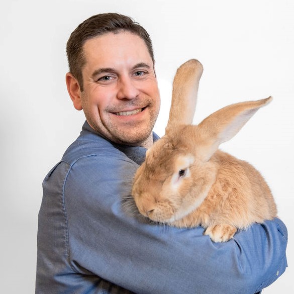 Brian smiling and holding a rabbit