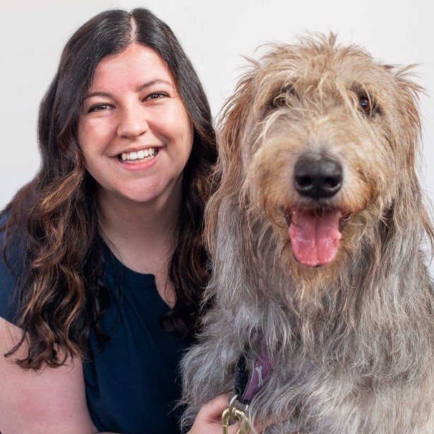 Terri Bastarache smiling with a dog