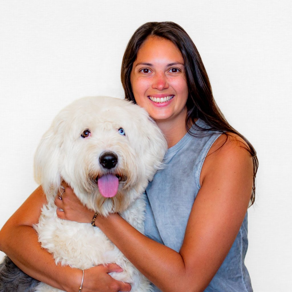 Alexis Wegrzynek smiling with a dog